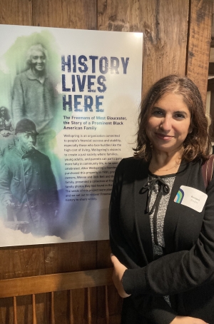Roopika Risam stands in front of the exhibit at Wellspring House, 'History Lives Here'